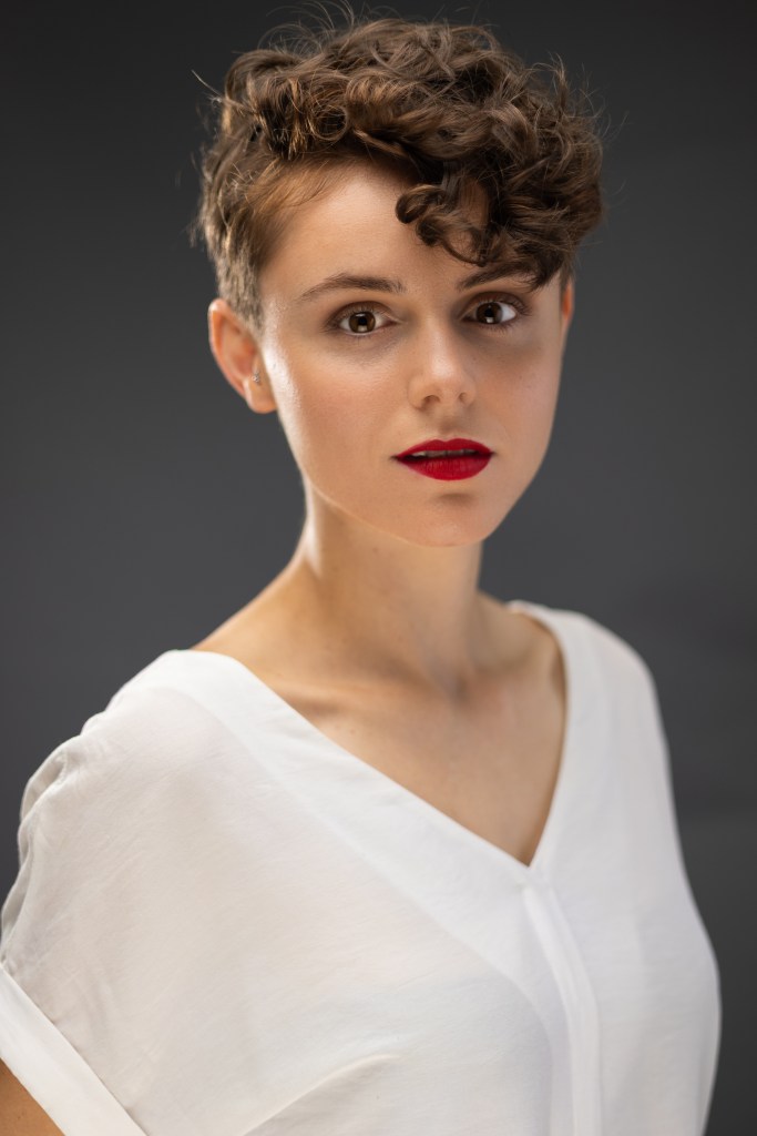 Amy staring calmly into the camera.